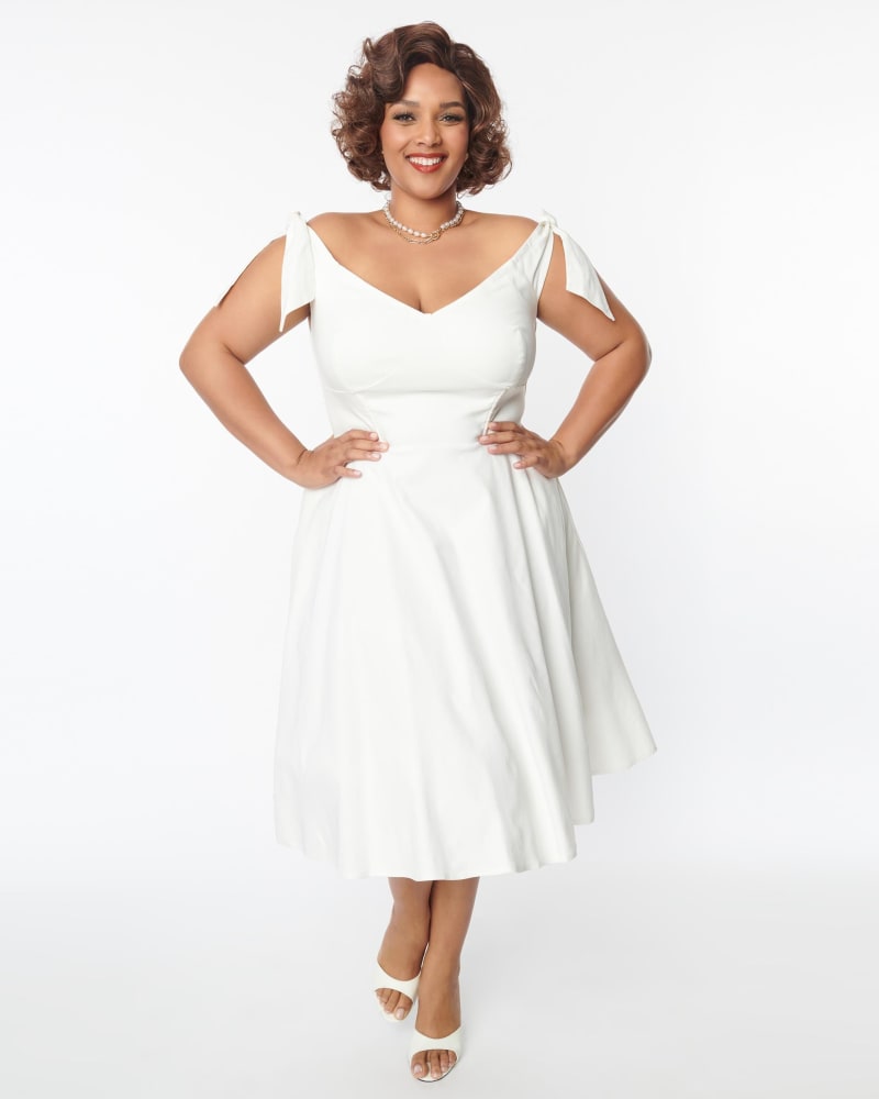 Front of a model wearing a size 2X Unique Vintage Off White Prairie Swing Dress in White by Unique Vintage. | dia_product_style_image_id:289235